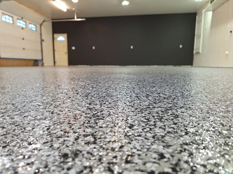 Before and after of successful concrete floor repairs for a garage.